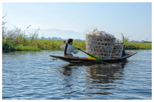 Woman transporting used  platic bottles on the Inle lake @ Giuseppe Salerno